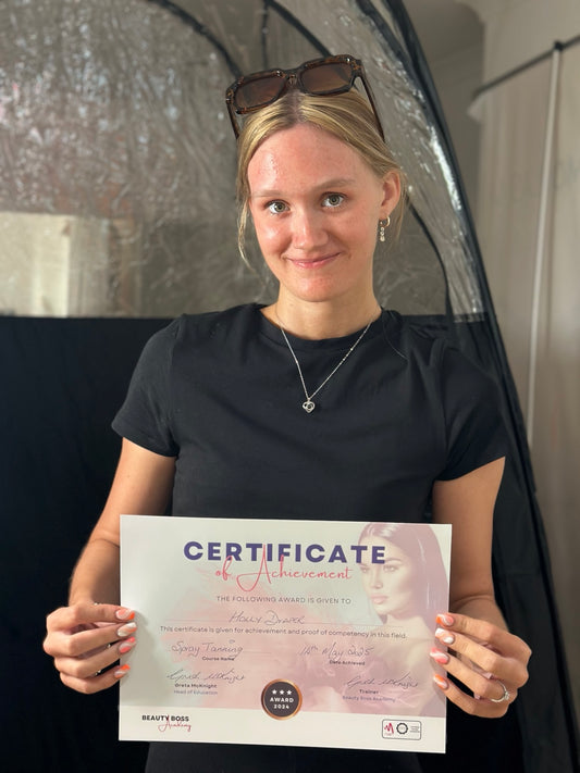 Beauty Boss Academy spray tanning student holding her training certificate in Stirling